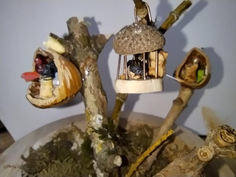 Un belvédère en bois et cupule de gland. Dedans une souris prépare une soupe dans un chaudron 