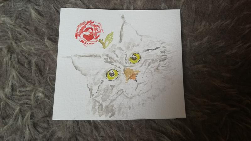 AquarelleTête d'un chat tigré gris. Une rose est au dessus de la tête 
