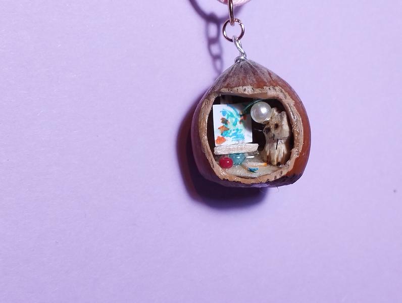 Pendentif noisette avec un chat et un tableau sur un chevalet 