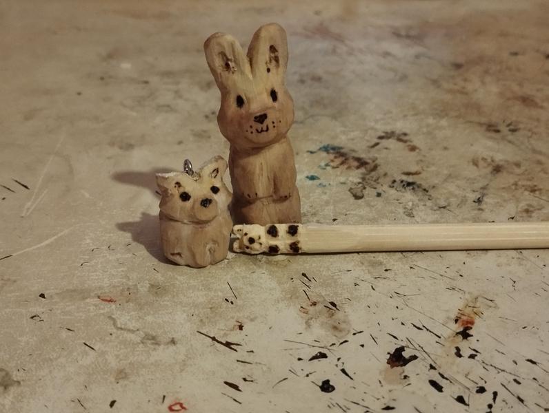 Un lapin en bous, un petit fennec et un ours sculpté sur une baguette 