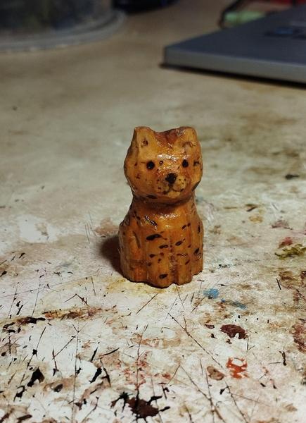 Un chat orange et tigré en bois