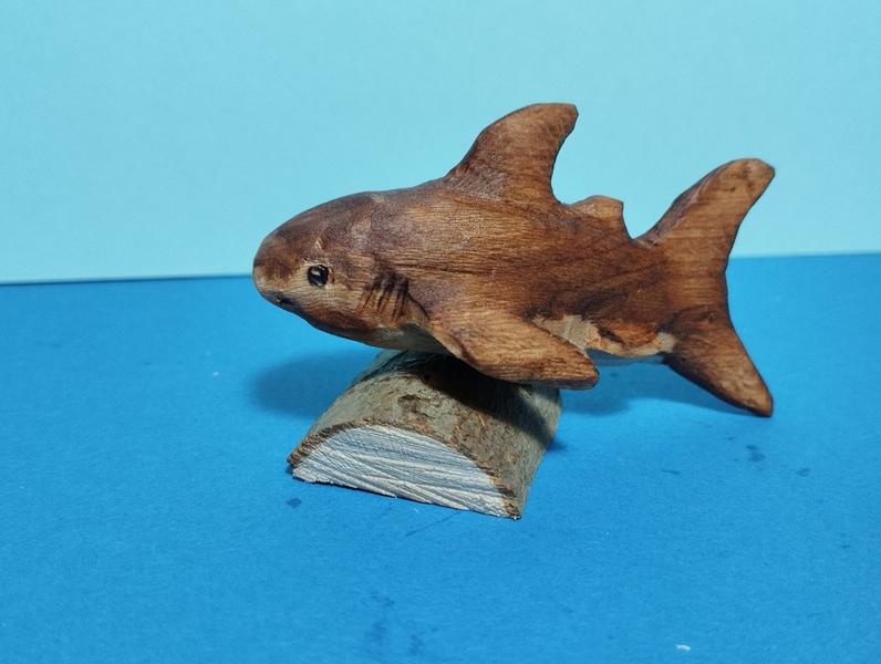 A wood sculpture of a shark