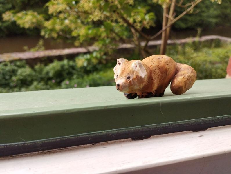 A woody sculpture of a red panda