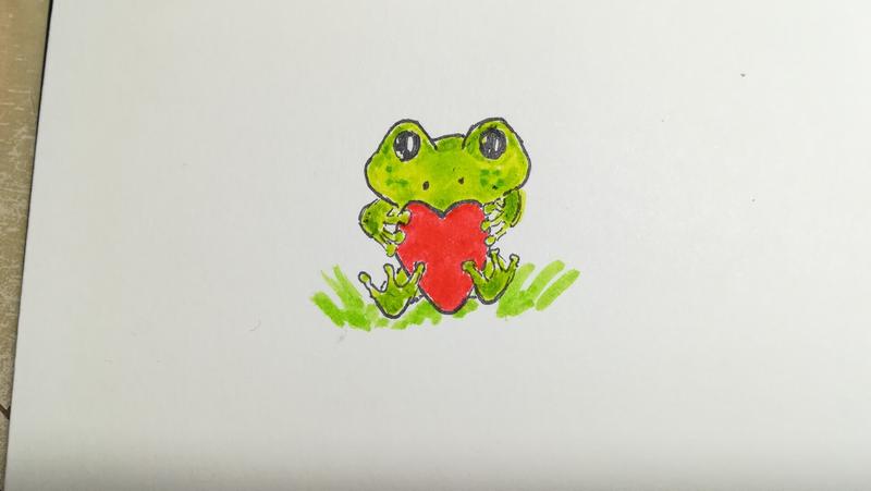 Dessin d'une grenouille qui tient un cœur 